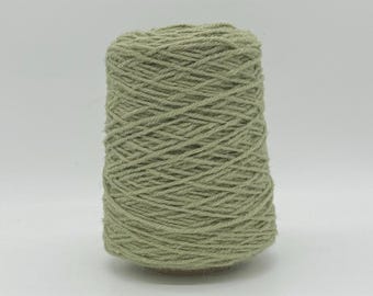 May include: A skein of light green yarn wound on a cardboard spool.