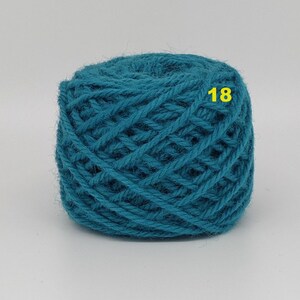 May include: A ball of teal yarn with a woven texture. The number "18" is printed in yellow on the yarn. This yarn is suitable for knitting, crocheting, and other fiber crafts.