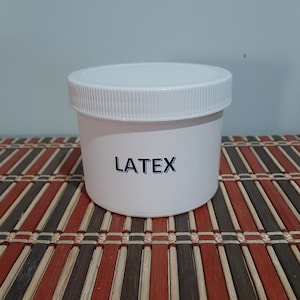 May include: White plastic container with a black label that says "LATEX".