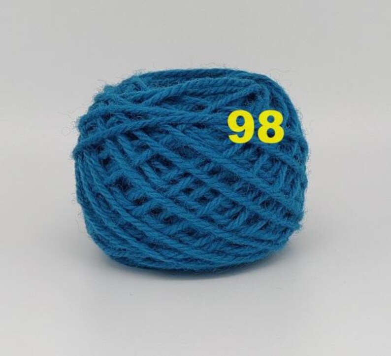 May include: A ball of teal yarn with the number 98 in yellow. The yarn is tightly wound, showing the texture of the fibers. The color is a vibrant, medium shade of blue-green, suitable for various knitting or crochet projects.