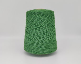 May include: A spool of green yarn, wound tightly and ready for knitting or crocheting.