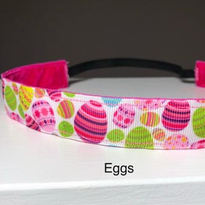 A white headband with a pattern of colorful Easter eggs.