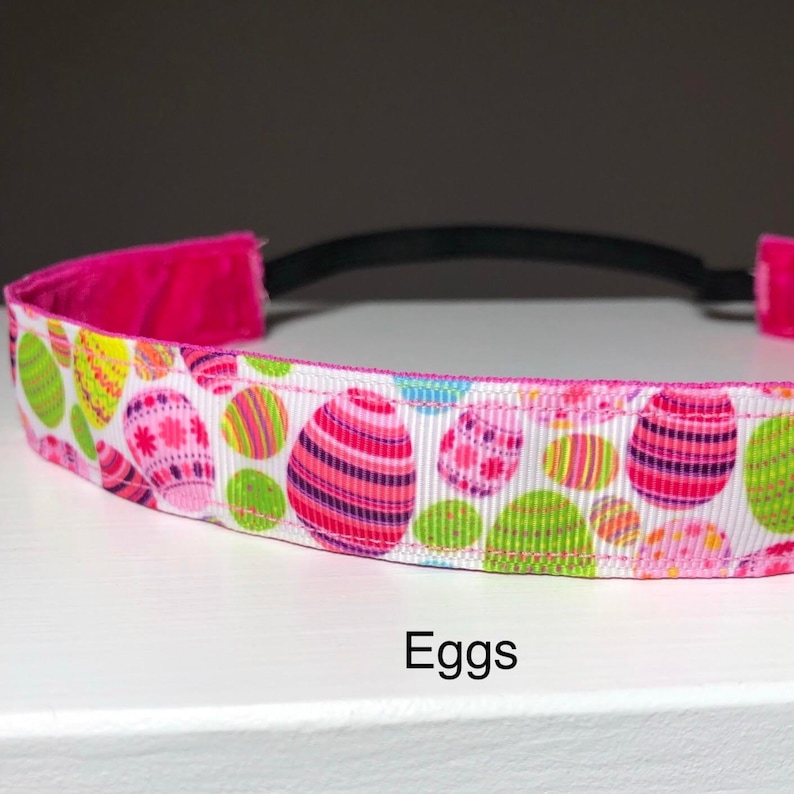 A white headband with a pattern of colorful Easter eggs.