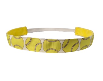 May include: A white headband with a yellow tennis ball pattern. The headband is made of a soft, stretchy material and is perfect for keeping hair out of your face during a workout or while playing sports.