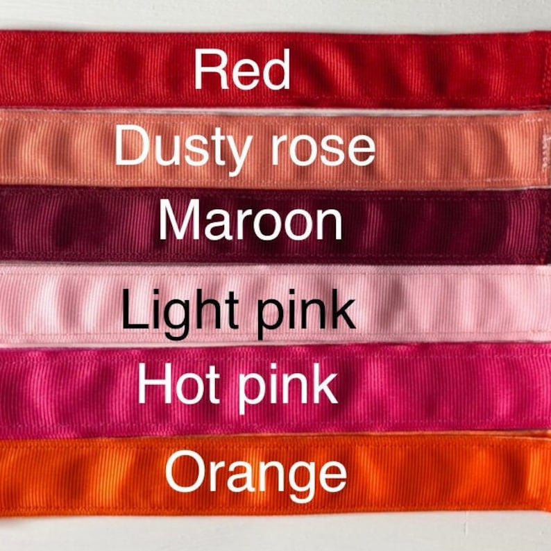 Six different colored ribbon samples, from top to bottom: red, dusty rose, maroon, light pink, hot pink, and orange.