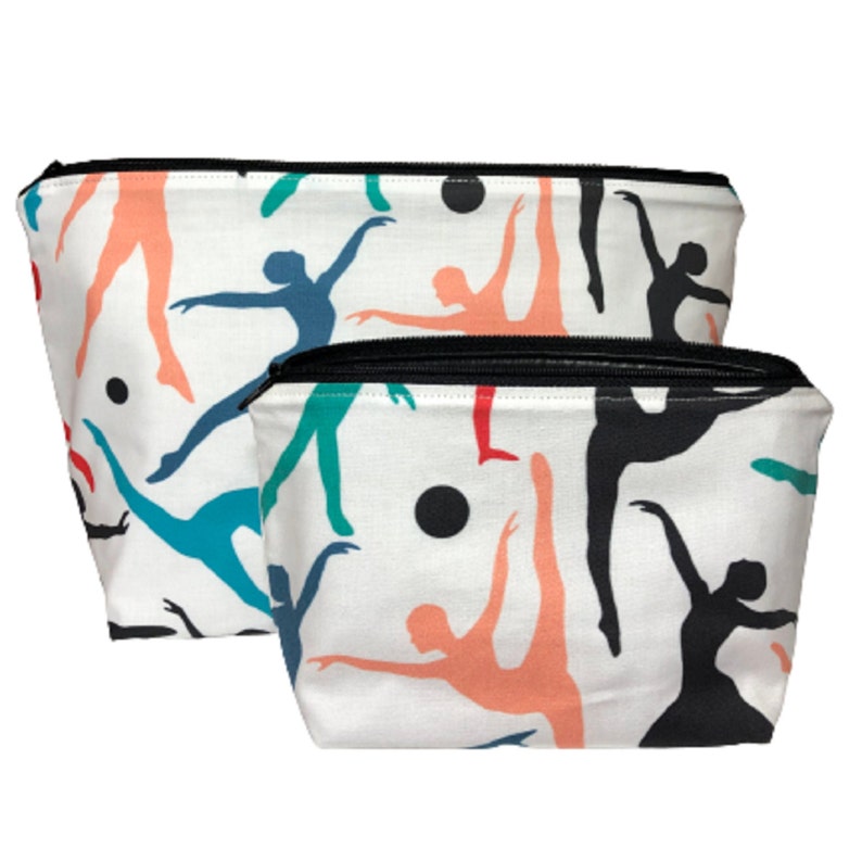 Two white zippered pouches with a black zipper. The pouches are decorated with a repeating pattern of colorful dancers in various poses.