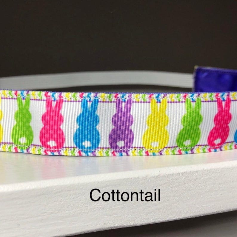 A white headband decorated with a repeating pattern of colorful Easter bunny silhouettes. The text "Cottontail" is printed below the headband.