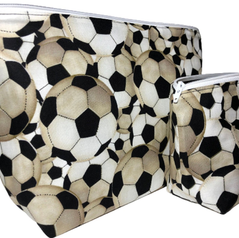 Two zippered pouches with a black and white soccer ball pattern.