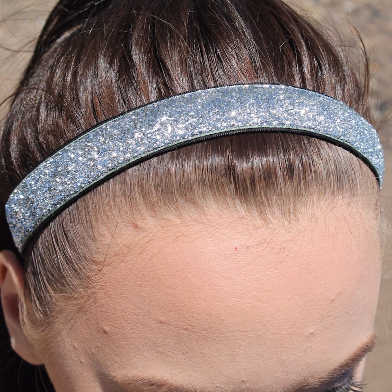 May include: A silver glitter headband for women. The headband is made of a soft, stretchy material and is perfect for keeping hair out of your face.