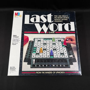 May include: A board game box cover with a green and black game board, letter tiles, and colorful game pieces. The game is called "Last Word" and is from the makers of "Upwords".