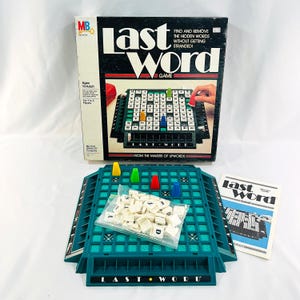 May include: A green and blue board game called "Last Word" with a grid of letters and colored pegs. The game box is in the background and says "Find and remove the hidden words without getting stranded!"  The game is from the makers of Upwords.
