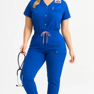 Koningsblauwe jumpsuit-scrub met knoop aan de voorkant