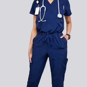 Navy blue jumpsuit scrub soft stretch fabric. Has Zipper at the crotch for bathroom. Also at www.Jocciniscrubs.com image 1
