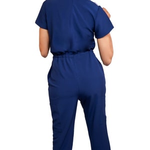 Navy blue jumpsuit scrub soft stretch fabric. Has Zipper at the crotch for bathroom. Also at www.Jocciniscrubs.com image 3