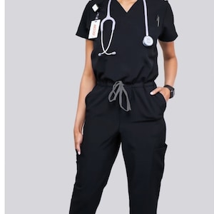 Black jumpsuit scrub soft stretch fabric. Runs big. Has Zipper at the crotch for bathroom. Also at www.Jocciniscrubs.com. 2 weeks to return.