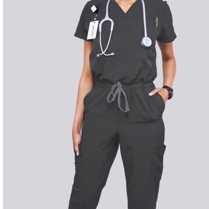 Gray jumpsuit scrub (Dark gray). Soft stretch fabric. Has Zipper at the crotch. Runs big. Also at www.Jocciniscrubs.com. 2 weeks to return.