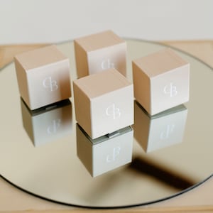 Jewelry gift packaging with logo boxes. Eco-friendly boxes for handmade opal and aquamarine studs.