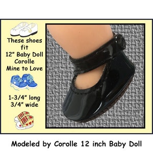 May include: Black patent leather shoes with a strap and buckle closure. These shoes fit 12 inch Corolle Baby Dolls. The shoes are 1 3/4 inches long and 3/4 inches wide. "These shoes fit 12" Baby Doll Corolle Mine to Love 1-3/4" long 3/4" wide Modeled by Corolle 12 inch Baby Doll"