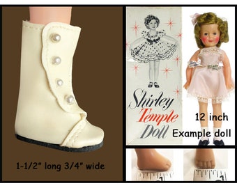 May include: Cream-colored doll boot with pearl-like buttons, 1.5 inches long and 0.75 inches wide. The image includes a vintage Shirley Temple doll and packaging. The doll is wearing a pink dress. The text says "Modeled by 12 inch Shirley Temple Doll."