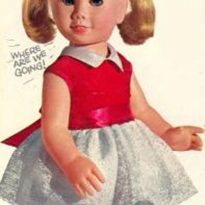 May include: A Chatty Cathy doll with blonde hair in pigtails, wearing a red dress with a white collar and a white lace skirt overlay. The doll has red shoes and white socks. Text reads: I'm Chatty Cathy, I can say 18 different phrases, MATTEL.