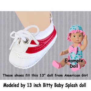 May include: White sneakers with red stripes and white laces. The shoes are modeled on a 13 inch doll. The doll is wearing a pink swimsuit and a pink and white hat. The text "Example Doll" is visible in the image.