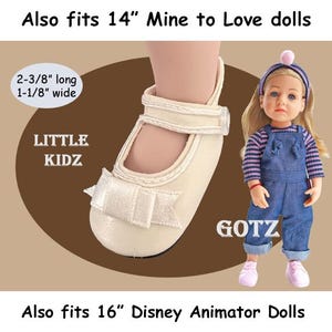 May include: Cream-colored doll shoe with a bow, designed for 14-inch Mine to Love dolls. The shoe is 2-3/8 inches long and 1-1/8 inches wide. The image also shows a doll wearing denim overalls and a striped shirt.