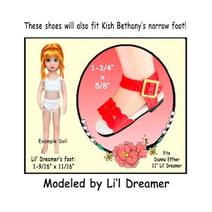 May include: Red doll sandals with a gold buckle, shown on a doll's foot. The sandals are 1-3/4" long and 5/8" wide. The image includes a doll and text that reads "Modeled by Li'l Dreamer."