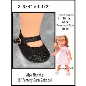 May include: Black glitter doll shoes with a buckle closure. The shoes measure 2-3/4 inches long and 1-1/2 inches wide. The text states that the shoes fit 18-inch Gotz Precious Day Dolls and 18" Pottery Barn Gotz dolls.