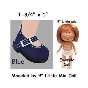 May include: A blue doll shoe with a white buckle and stitching, measuring 1-3/4" x 1". The image also shows a 9" doll with red hair and white underwear. The text reads "Blue" and "Modeled by 9" Little Mia Doll."