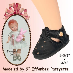 May include: Black doll shoe with a button closure, measuring 1-3/8" x 3/4". The shoe is shown on a doll's foot. An example doll is shown holding a pink stuffed bunny. The text says "Modeled by 9" Effanbee Patsyette."