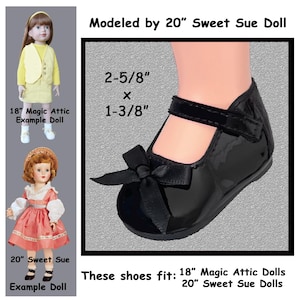 May include: Black patent leather doll shoe with a bow and strap. The shoe measures 2-5/8 inches long by 1-3/8 inches wide. The text indicates the shoes fit 18" Magic Attic Dolls and 20" Sweet Sue Dolls.