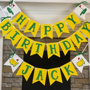 May include: A yellow and green banner with the words "Happy Birthday Jack" and golf-themed decorations.