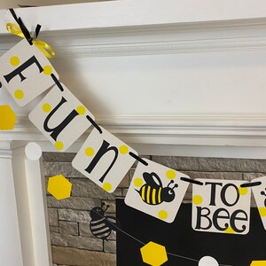 May include: A white and black banner with the words "Fun to Bee" and yellow honeycomb and bee illustrations.