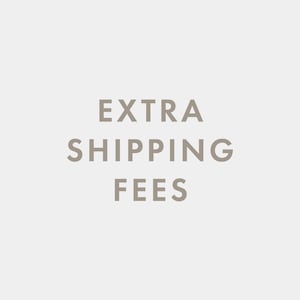 May include: Text that reads "EXTRA SHIPPING FEES" in a light brown color against a white background.