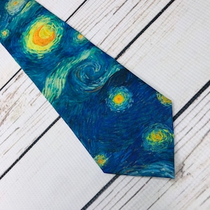 May include: A blue necktie with a printed design of Van Gogh's Starry Night.