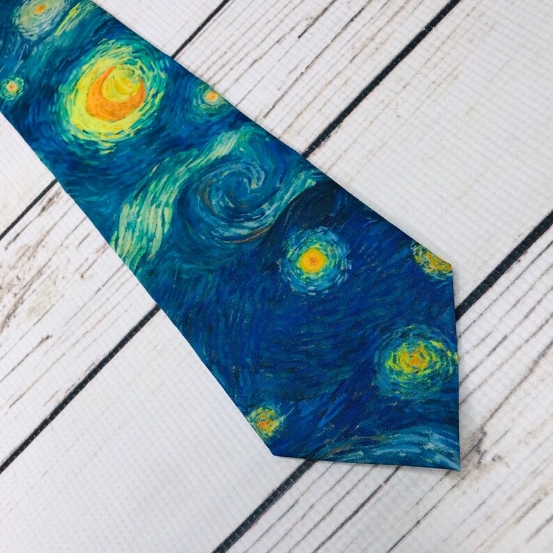 May include: A blue necktie with a printed design of Van Gogh's Starry Night.