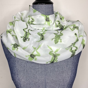 May include: White silk scarf with a green skeletal frog print.
