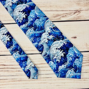 May include: A blue and white tie with a wave pattern. The waves are stylized and resemble a Japanese art print.