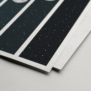 May include: Close-up of a stack of printed cards with a white border. Each card features a black background with white dots and a white circle in the top left corner.