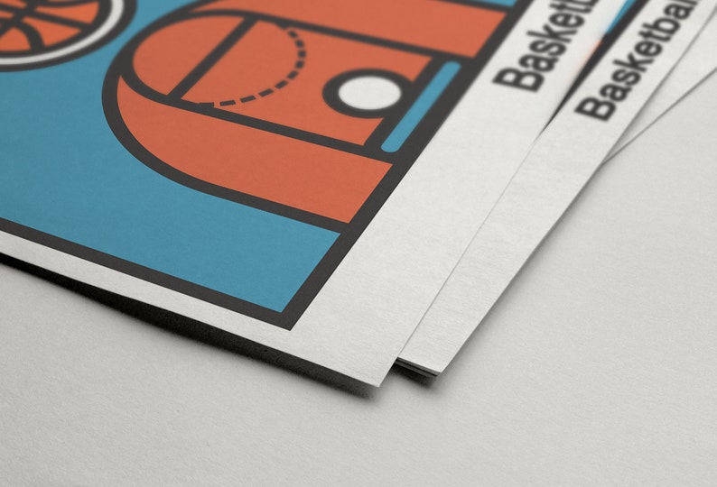 May include: A stack of basketball-themed posters. The top poster features a basketball court design in orange, blue, and black. The word "Basketball" is printed on the side of the posters.