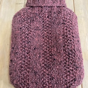 Pink and black hot water bottle cover knit with a merino/silk/cashmere blend