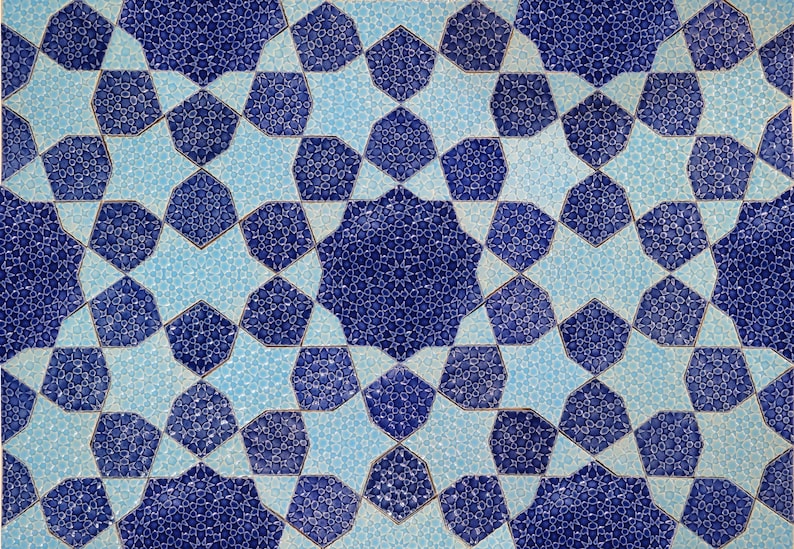 May include: Close-up of a decorative tile pattern featuring a repeating geometric design. The pattern uses shades of blue and light blue, creating a symmetrical star-like motif. The intricate design is suitable for home decor.