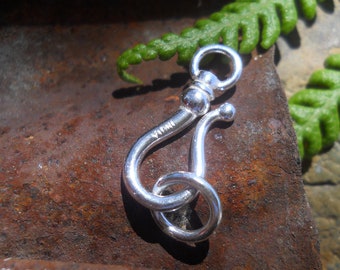 May include: Silver clasp with a loop and a hook. The clasp is marked with the word "YIMI".