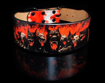 May include: A black dog collar with a red and black graphic design featuring snarling dog faces. The collar has a red and white spotted buckle and a natural leather interior.