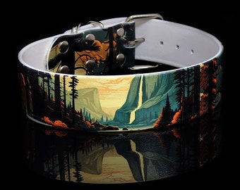 May include: A white leather dog collar with a colorful landscape print featuring a waterfall, mountains, and trees. The collar has a silver buckle and metal rivets.