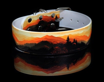May include: White leather dog collar with a colorful sunset and mountain scene printed on it. The collar has a silver buckle and is designed for a medium-sized dog.