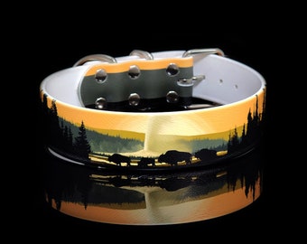 May include: White leather dog collar with a black and gold sunset scene and silhouette of bison. The collar has silver hardware.