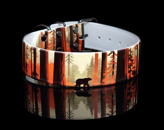 May include: A white leather dog collar with a black bear and forest scene print. The collar has black metal hardware and is adjustable.