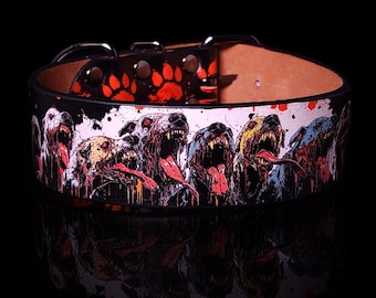 May include: Black leather dog collar with a graphic print of a row of snarling zombie dogs with red, yellow, and blue accents. The collar has red paw prints on the top.