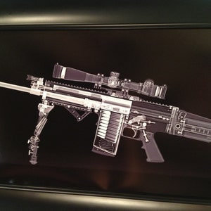 May include: An x-ray image of a rifle with a scope, bipod, and magazine. The rifle is depicted in shades of gray and white against a black background. The internal mechanisms of the rifle are visible.